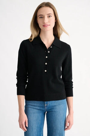 A woman wearing the KINROSS CASHMERE Crystal Button Cashmere Polo in black, featuring five decorative silver buttons, shown from the shoulders up against a plain background.