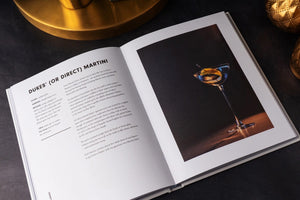 The Martini Cocktail Guide Book by Alice Lascelles from Chronicle Books features a classic martini glass with a green olive on a dark blue cover and the subtitle: "The Ultimate Guide to a Cocktail Icon and Essential Martini Recipes.