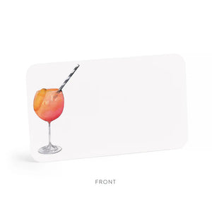 A clear box contains "E. FRANCES PAPER - APEROL SPRITZ LITTLE NOTES" featuring tiny notecards. The front card displays a watercolor of a cocktail with a striped straw and the phrase "use unsparingly.
