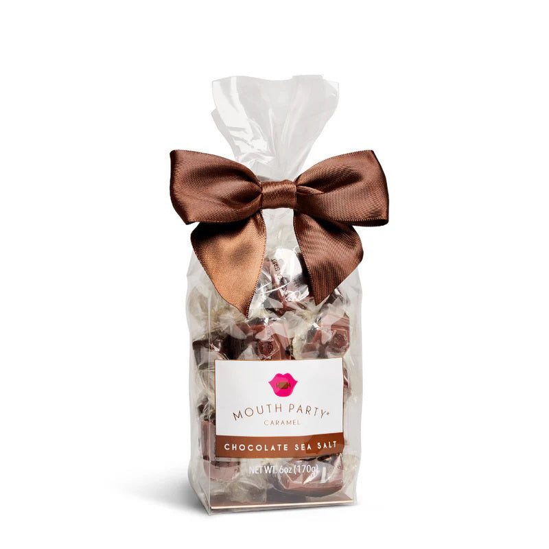 A clear bag of MOUTH PARTY - CHOCOLATE SEA SALT caramels from MOUTH PARTY, tied with a shiny brown ribbon. The label features a pink lips logo and product details.