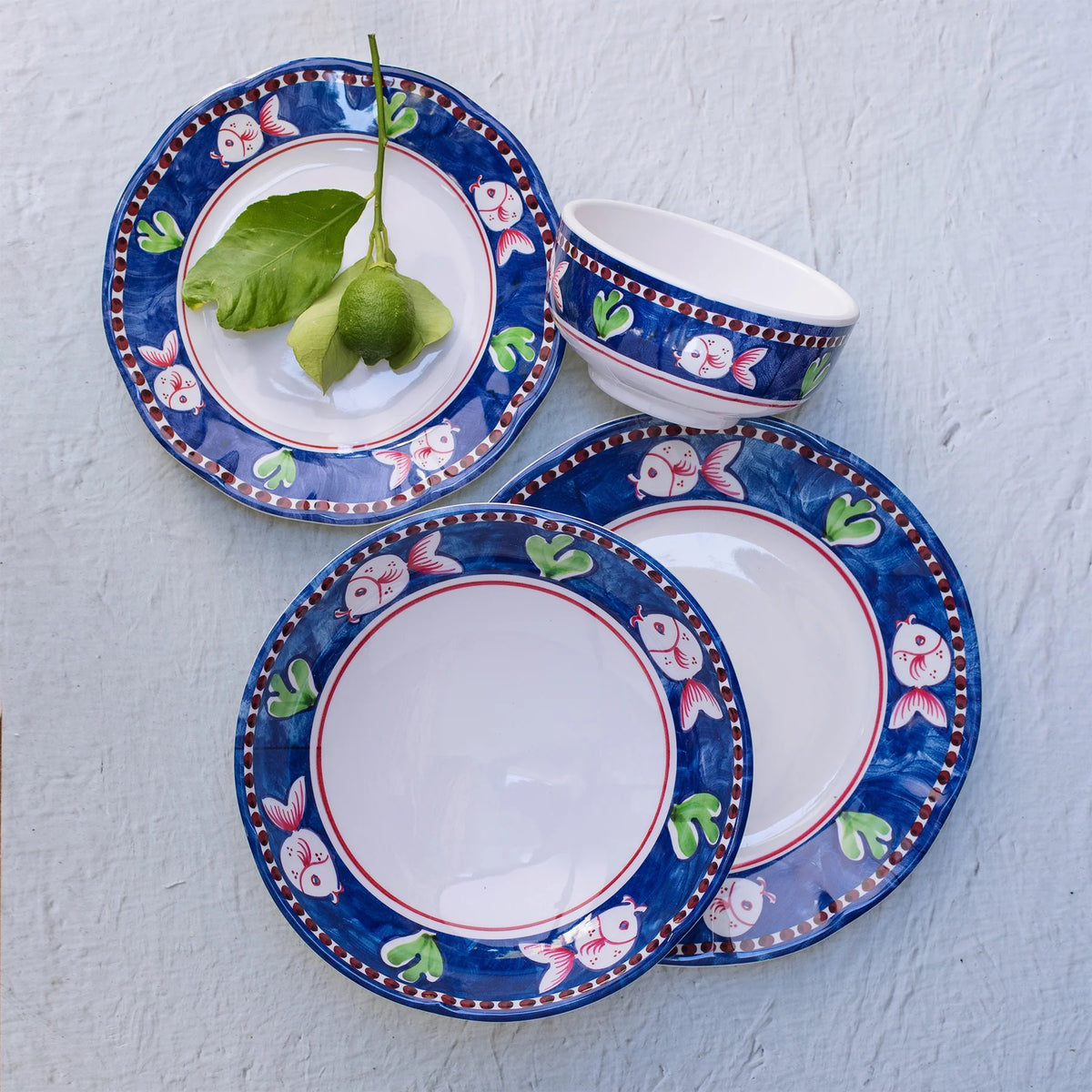 The VIETRI Melamine Campagna Pasta Bowl features a red interior with playful pig and fruit designs, a blue patterned edge, and a durable white melamine build—perfect for outdoor dining.