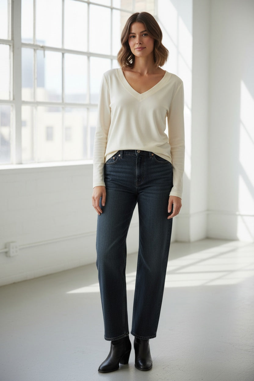 The MOMONI - TERENCE V NECK TOP by MOMONI is a long-sleeved, cream silk crepe blouse with a V-neckline and cuffed sleeves, shown laid flat on a white background.