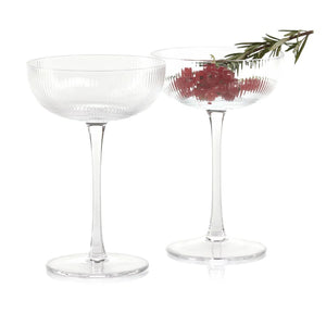 The ZODAX OPTIC DESIGN MARTINI GLASS, with its wide, shallow bowl and slender stem, stands upright against a white background—ideal for modern bars or as an elegant martini glass alternative.