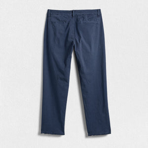 A pair of FRANK & EILEEN’s THE WICKLOW Italian Chinos in Performance Twill, featuring a navy blue color, straight legs, and raw unfinished hems, is laid flat on a light textured background for an Italy-meets-California vibe.