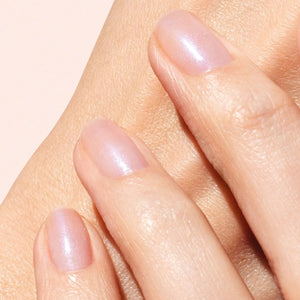 A nail polish brush and swatches appear beside text featuring the MANUCURIST - ACTIVE™ BRIGHT TREATMENT POLISH by MANUCURIST INC, emphasizing easy application, fast drying, a buildable make-up effect, and an enriched formula with active ingredients—perfect for plant-based nail care or as a brightening treatment polish.