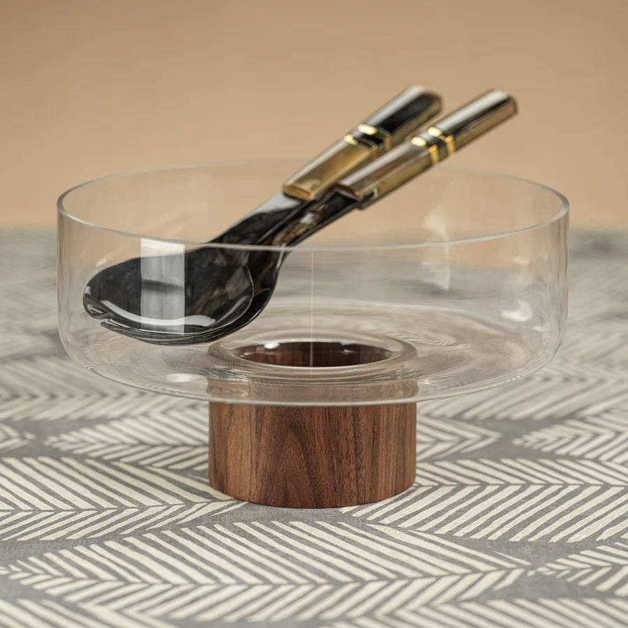 The SEYCHELLES HORN SALAD SERVER SET by ZODAX features two dark-hued serving spoons with round bowls and gold-tan accented handles, ideal for luxury home décor or as an elegant hostess gift. Displayed on a white background.