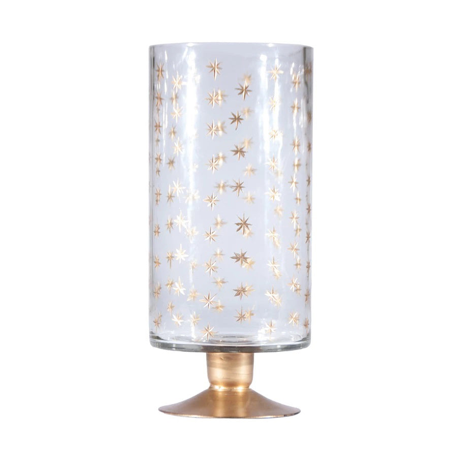 The HAND PAINTED ETCHED GLASS FOOTED HURRICANE by CREATIVE COOP features clear etched glass with a gold starburst pattern and sits on a small, round, luxe gold-finished base.