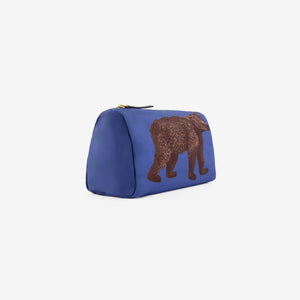 The INOUI EDITIONS - BEAR COSMETIC POUCH by INOUI is a blue zippered pouch made in India, featuring a detailed illustration of a brown bear walking, shown against a plain white background.