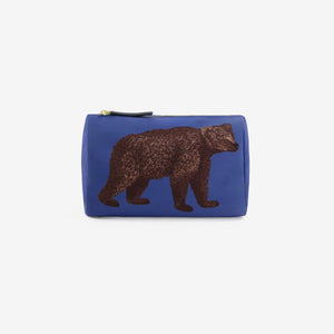 The INOUI EDITIONS - BEAR COSMETIC POUCH by INOUI is a blue zippered pouch made in India, featuring a detailed illustration of a brown bear walking, shown against a plain white background.
