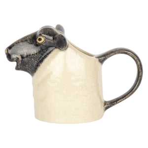 The QUAIL CERAMICS - BLACK SUFFOLK SHEEP JUG by QUAIL DESIGNS features realistic black ears, a black nose, and yellow eyes—perfect for adding farmhouse charm to your kitchen decor.