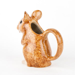 The QUAIL CERAMICS - WOOD MOUSE JUG by QUAIL DESIGNS is a hand-painted stoneware jug shaped like a seated brown mouse, featuring a textured, fur-like surface. Its handle forms the tail and the pour spout is at the mouth. Dishwasher safe, it sits against a plain white background.