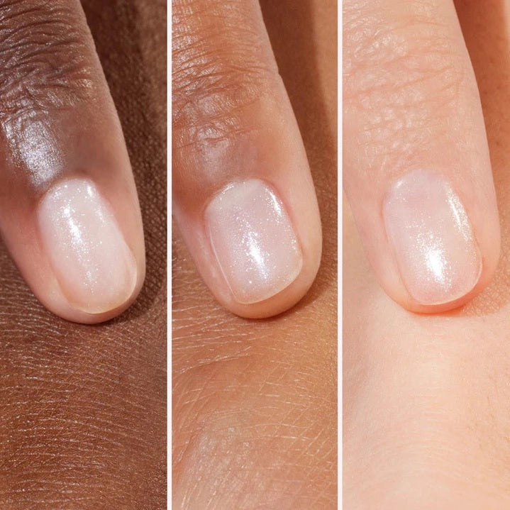 A clear bottle of MANUCURIST - ACTIVE™ SHINE TREATMENT POLISH by MANUCURIST INC features a white cap and a label that says “Nail Care Effects, Active Shine, Highlights & repairs.” This plant-based treatment polish contains a sparkly light pink formula that acts as both a hydrating highlighter and a nail strengthener.