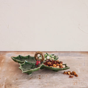 Two green CREATIVE COOP CERAMIC HOLLY LEAF SHAPED DISH serving platters, one with three sections and one with four, each featuring a central dark ring handle and red berries.