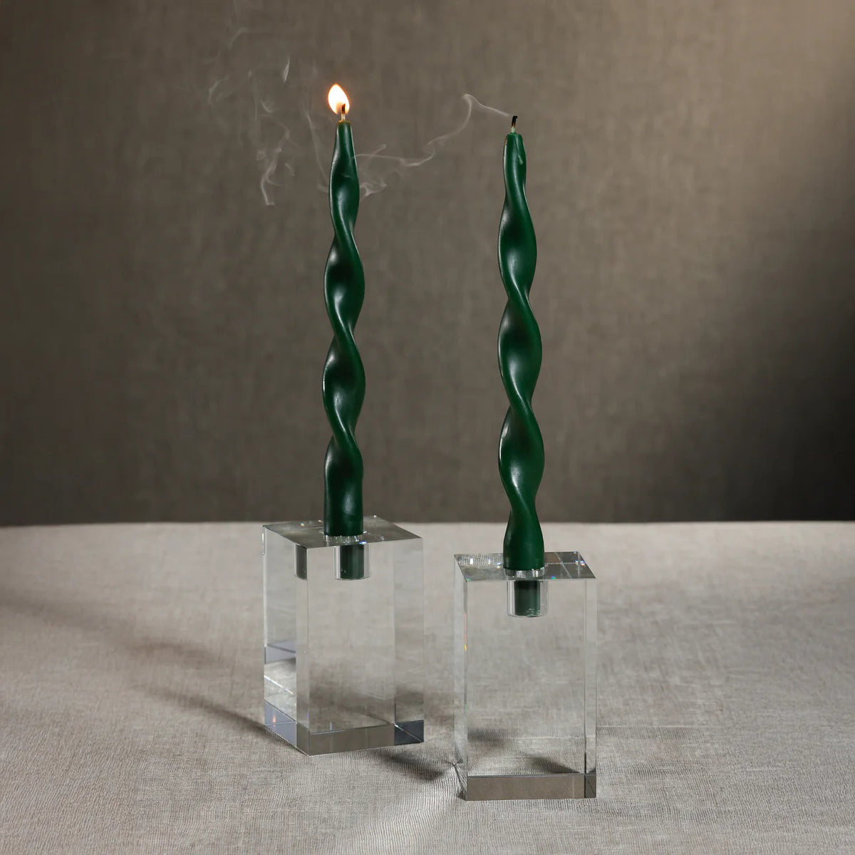 The ZODAX SQUARE CRYSTAL GLASS TAPER HOLDER 4.75&quot; is a transparent, rectangular glass holder with a square cap, shown on a white background. Its sharp edges and clean design make it a stylish decorative piece.