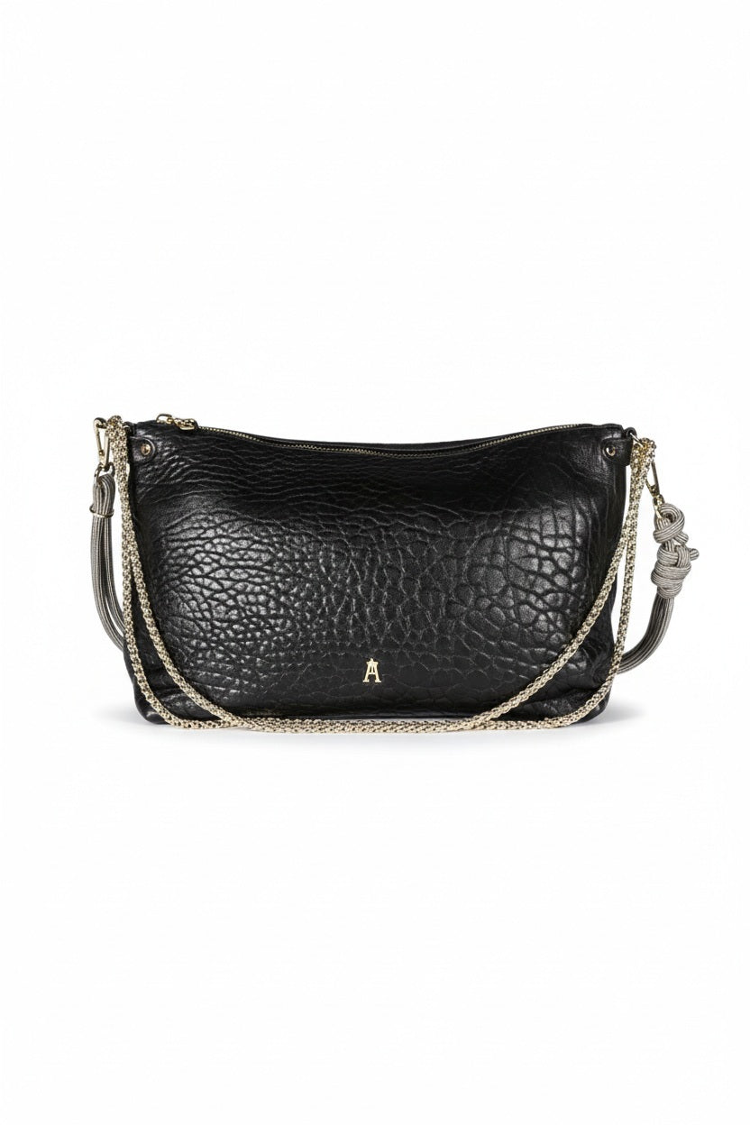 The CRAIE STUDIO - MALLOW BUBBLE NOIR HANDBAG features black bubble leather, a luxurious gold zipper, and an elegant gold chain strap. Displayed against a white background, this chic piece from CRAIE STUDIO adds sophisticated style to any outfit.