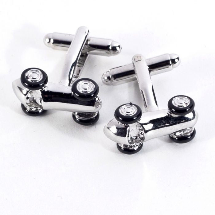 BEYBERK INTERNATIONAL's CUFFLINKS - RHODIUM PLATED RACE CAR CUFFLINKS feature distinctive small car designs with black wheels, set on a white background—an ideal choice for fans of unique men's accessories.