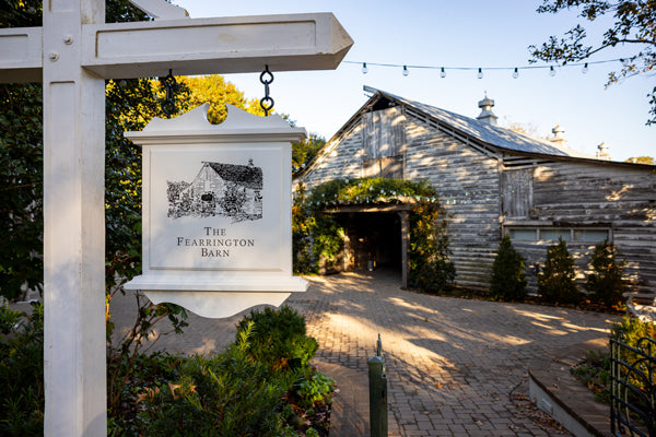 A white wooden sign reading 
