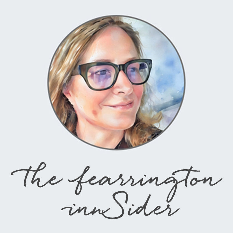 A digital portrait of a smiling person with long hair and black glasses, set inside a circular frame. Below, cursive text reads “The Fearrington innSider” on a light background.