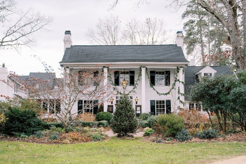 the fearrington house restaurant - large white house with black roof and decorated with christmas garlands on a clear day