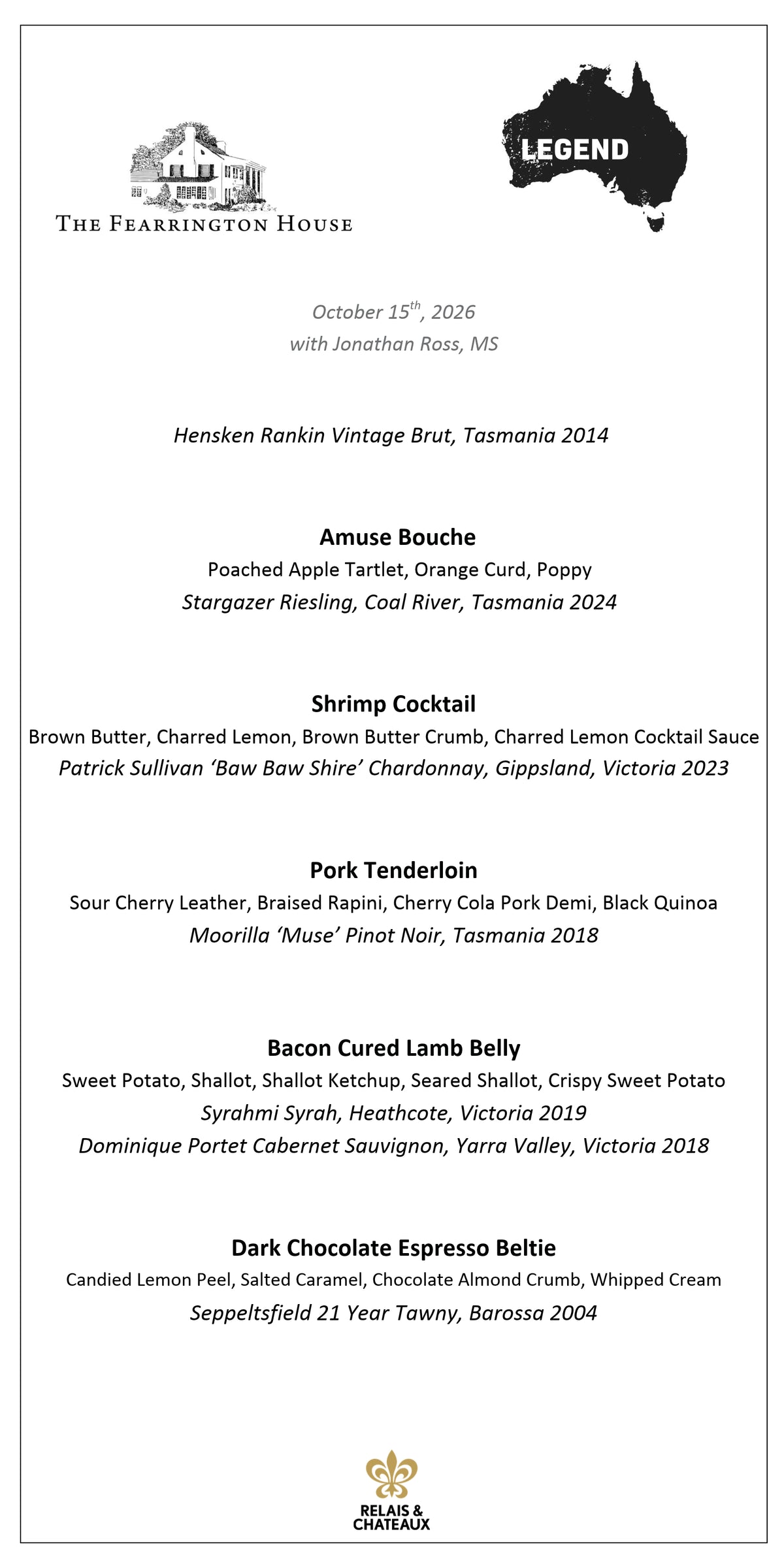 A bearded man with glasses, dressed in a blue suit jacket and light shirt, stands smiling in a warmly lit modern restaurant—Jonathan Ross, MS, Master Sommelier and guide for the Legend Wine Dinner with FEARRINGTON VILLAGE.