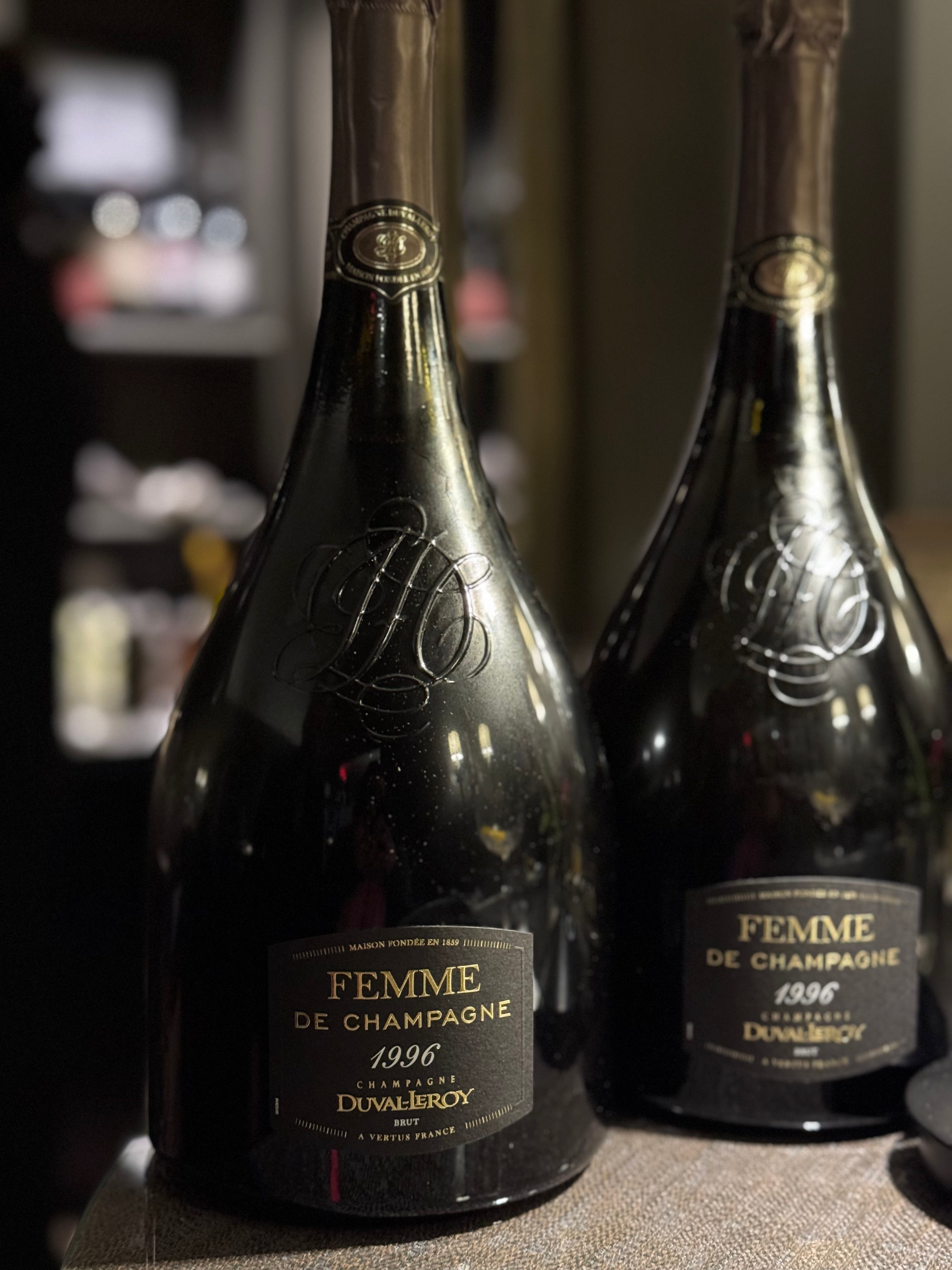 Two large dark champagne bottles labeled 