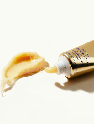 A gold tube of LANOLIPS - GOLDEN DRY SKIN MIRACLE SALVE from LANOLIPS, featuring blue text and a white cap. The label states “Made with Love and Lanolin” and describes it as an intensive hydration ointment for all-over use on dry skin.