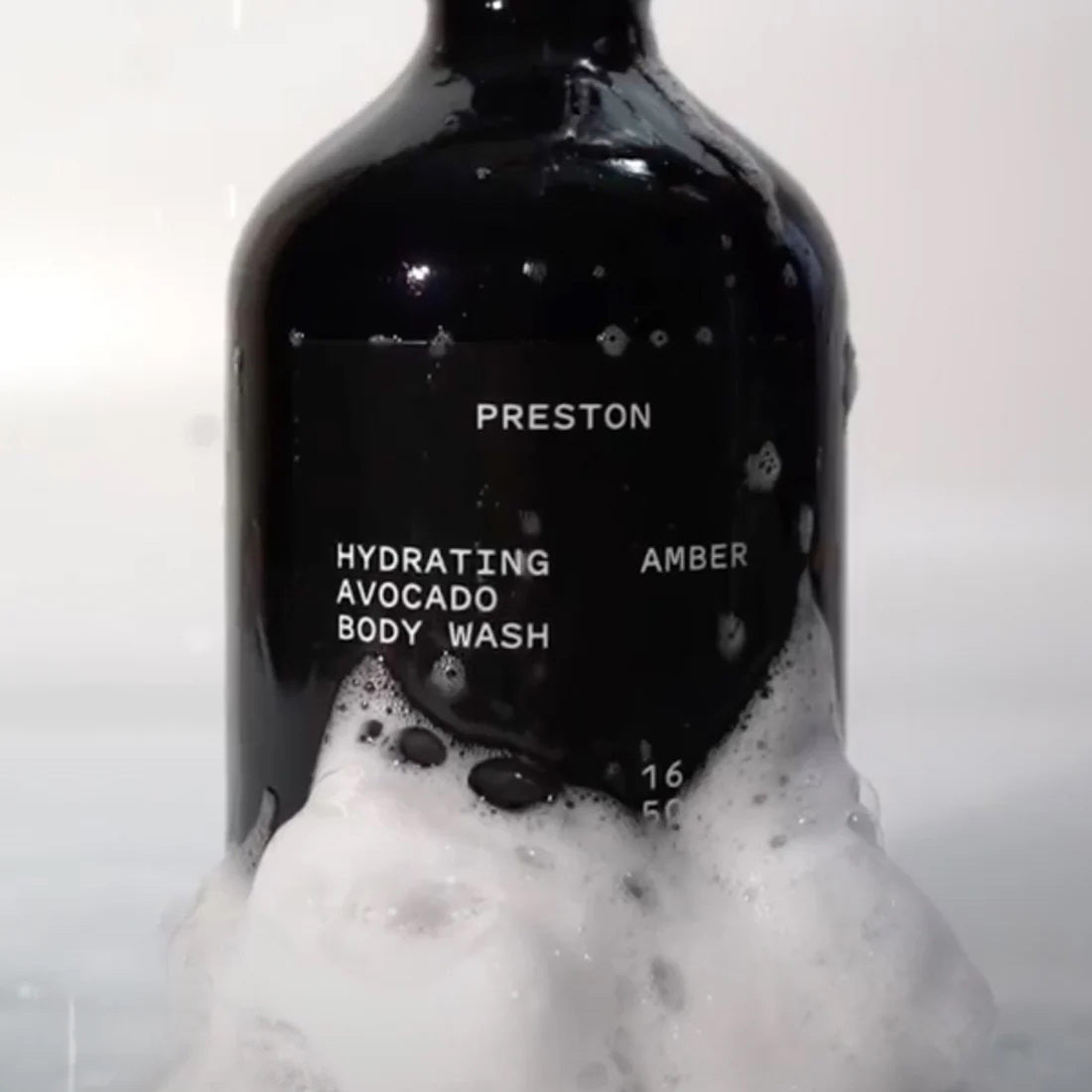 A black bottle of PRESTON - BODY WASH labeled 