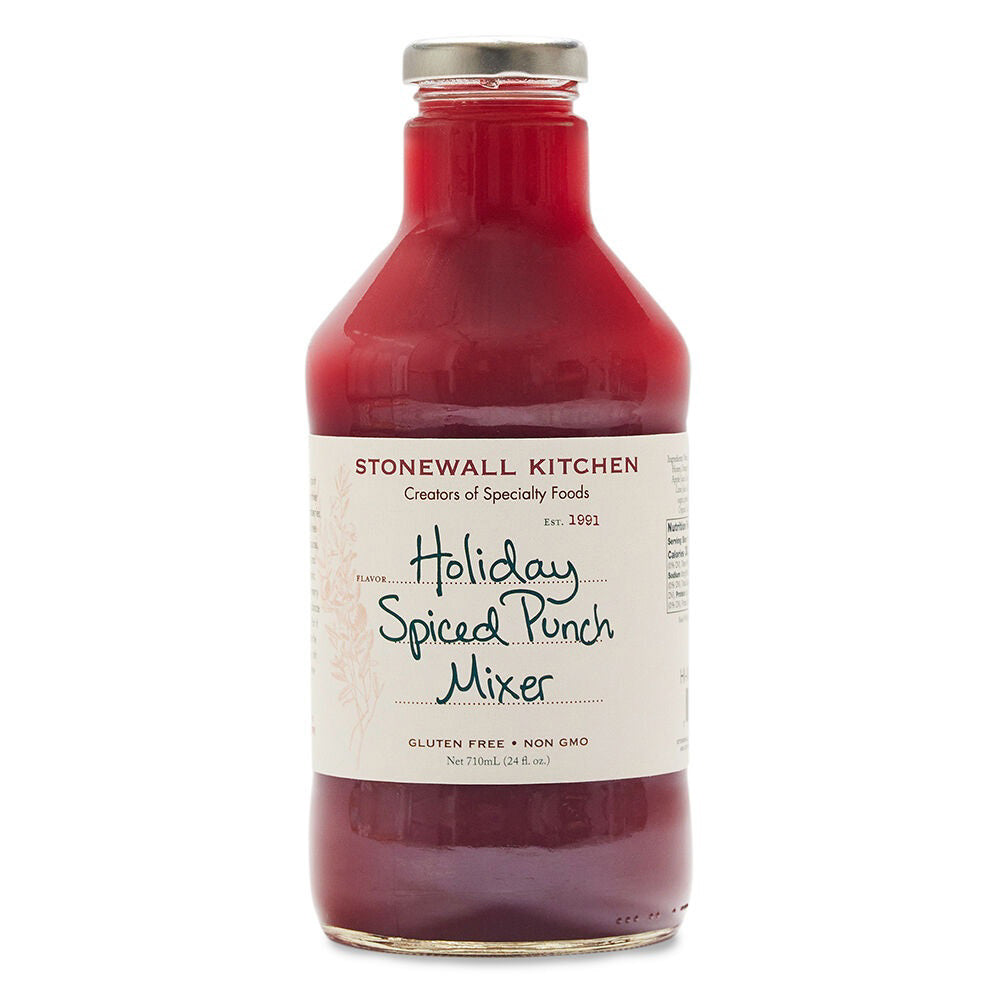 A bottle of STONEWALL KITCHEN - HOLIDAY SPICED MIXER showcases a festive blend of fruity flavors and warming spices in a rich red liquid. The label highlights its gluten-free, non-GMO qualities with the sweetness of organic wildflower honey, all securely sealed with a metal lid.