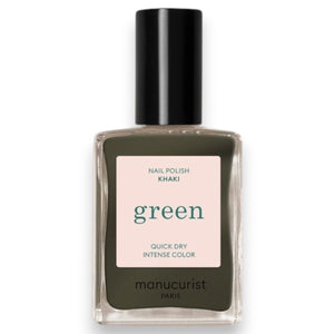 A hand with neatly manicured nails, painted in MANUCURIST - GREEN™ Nail Polish in Khaki by MANUCURIST INC, rests on a light beige fabric surface.