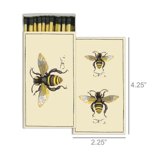 The HOMART MATCHES - BEES box contains yellow-tipped safety matches and features a vintage bee illustration on the box, with three labeled bees on an enclosed card—making it a delightful and charming hostess gift.