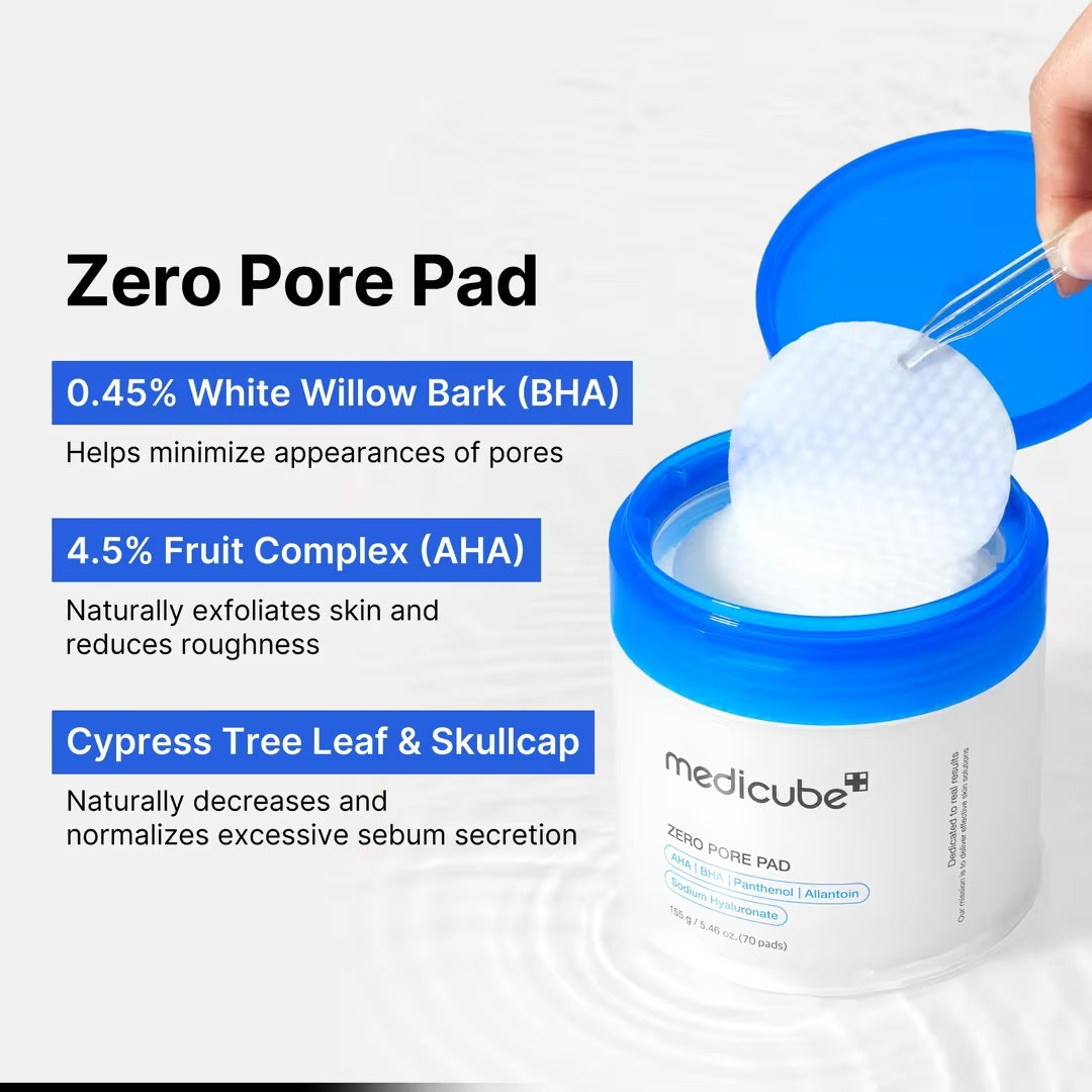 A hand holds a round, textured exfoliating pad above an open jar of KOSMIC KBEAUTY SKINCARE MEDICUBE - ZERO PORE PAD 2.0, 100ML, with its blue lid set aside on a plain white background.