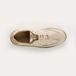The REQINS ATHENA GLAM sneaker in platinum off white features suede leather, a textured sole, and stitched details, displayed from the side against a plain light background.