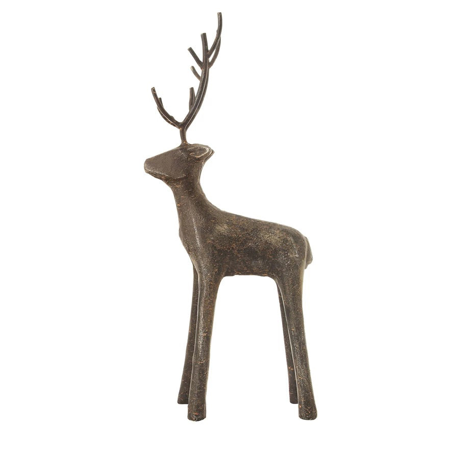 The CREATIVE COOP CAST IRON STANDING DEER features two minimalist black metal sculptures with tall antlers, displayed on wood chips against a white background, adding a striking modern touch to your holiday decor.
