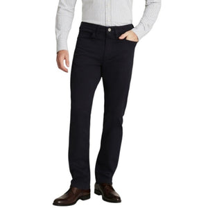 A man stands with his arms crossed, wearing a dark gray T-shirt and 34 HERITAGE - CHARISMA RELAXED STRAIGHT PANT IN NAVY TWILL, with only his upper body and waist shown against a plain white background.