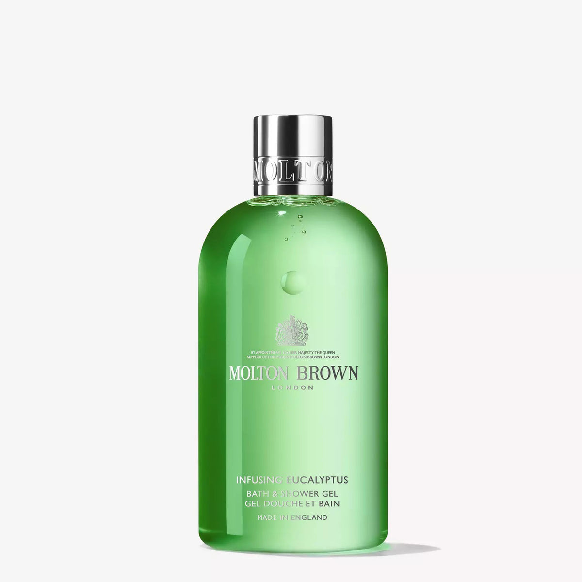A bottle of MOLTON BROWN - EUCALYPTUS BATH AND SHOWER GEL. The clear bottle contains green gel and is topped with a metallic silver cap. The label showcases the Molton Brown logo and details in elegant text, highlighting that it is made in England and is enriched with notes of wild mint for a refreshing touch.