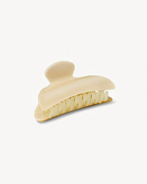 The MACHETE - MIDI HEIRLOOM CLAW by MACHETE is featured against a plain white background. This cream-colored hair accessory is crafted from luxurious Italian acetate and features curved edges with interlocking teeth, making it ideal for securing medium hair with effortless style.