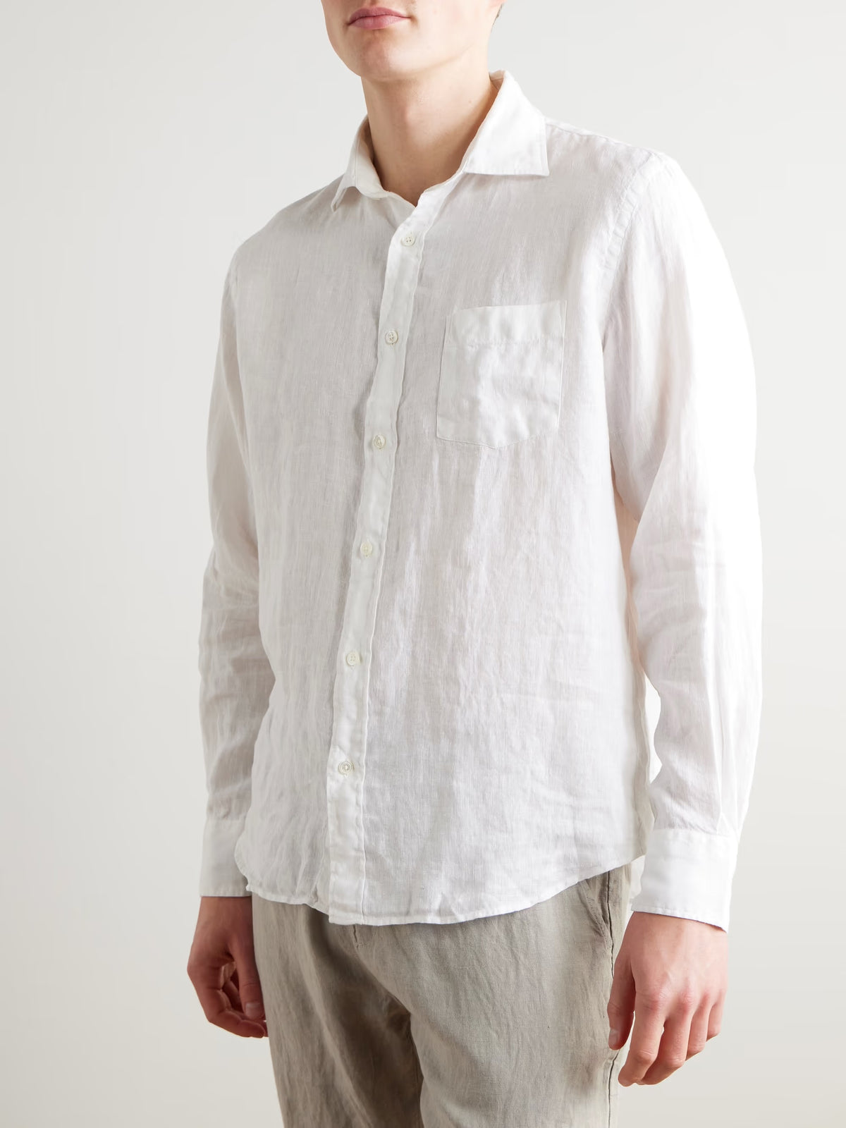 The HARTFORD - PAUL LINEN SHIRT IN WHITE by HARTFORD is a long-sleeved, button-up men's shirt crafted from premium European Flax linen, featuring a collar and single chest pocket, shown flat on a plain light grey background.