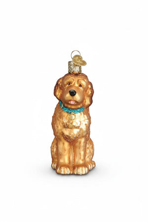 Old World Christmas IRISH DOODLE ORNAMENT, a golden-colored glass dog sitting and wearing a bright blue collar with a small tag.