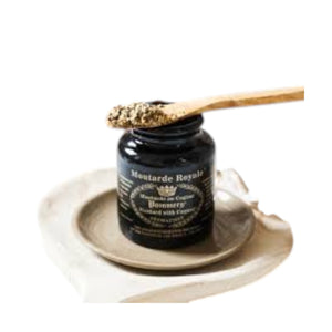 A black ceramic jar with gold text and designs, labeled “FRENCH ROYAL MUSTARD WITH COGNAC” by FRENCH FEAST, features a crown and laurel wreath. This elegant jar holds authentic mustard, sealed with gold wax on the lid.