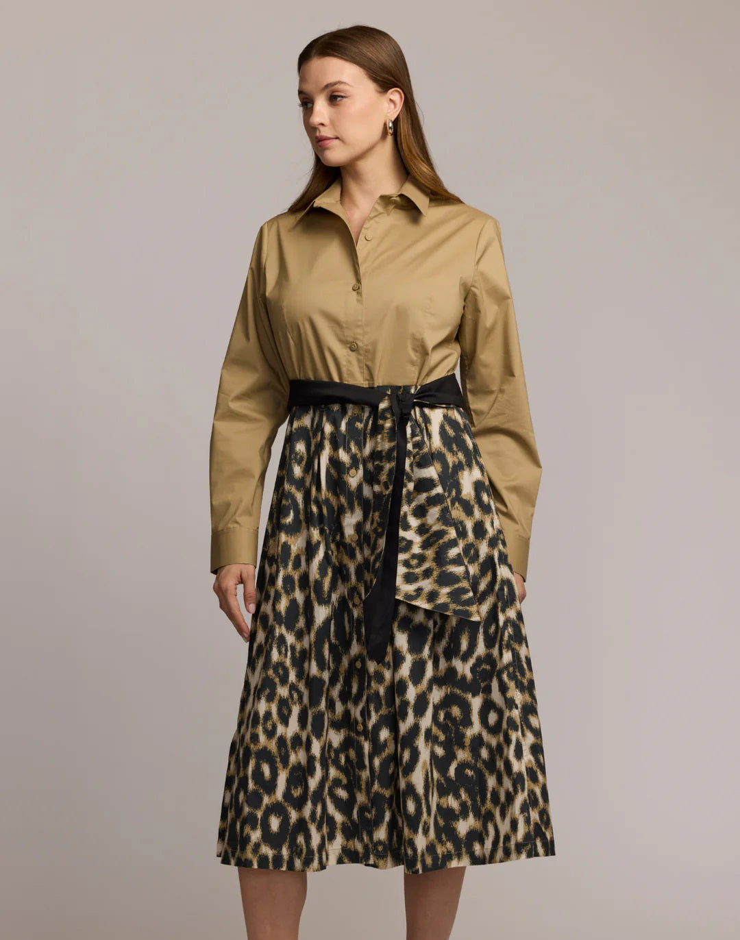 A woman wears the HINSON WU Robin Long Sleeve Combo Dress in animal print, featuring a tan button-up top and high-waisted leopard skirt with a black belt, set against a plain light background.