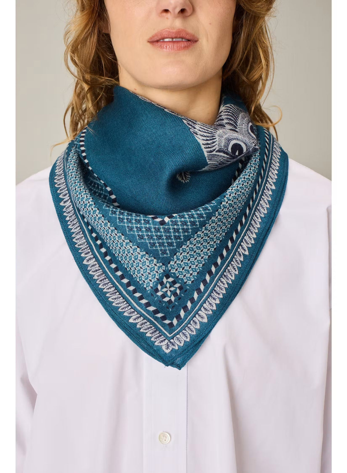 A detailed illustration of a cat and an owl sitting side by side on a branch, bordered by an intricate blue and white pattern, evokes the fine craftsmanship of the INOUI EDITIONS - CHOUETTE SQUARE SCARF IN BLUE by INOUI.