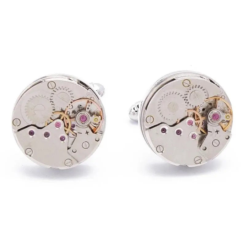 STOLEN RICHES - WATCH MOVEMENT CUFFLINKS by STOLEN RICHES feature round silver designs with visible gears and gold and pink accents—a unique gift that's perfect for any men's accessories collection.