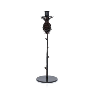 The ZODAX PINECONE WROUGHT IRON CANDLE HOLDER - TALL is a black candle holder with a pinecone design, slender branch-like stem, and round base.
