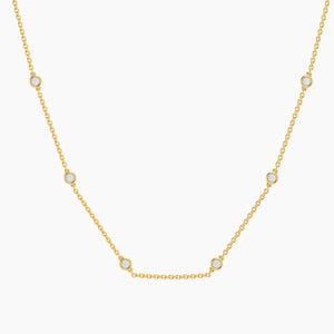 The ELLA STEIN - IN THE LOOP NECKLACE (16″) by ELLA STEIN is a delicate gold chain necklace featuring evenly spaced small round natural diamonds set in bezels along the chain.