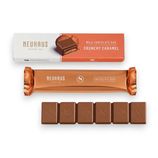 The NEUHAUS - MILK CHOCOLATE CRUNCHY CARAMEL BAR is displayed in its open wrapper, revealing six pieces of milk chocolate with caramel and crunchy biscuits, alongside the outer box featuring NEUHAUS branding and the product name.
