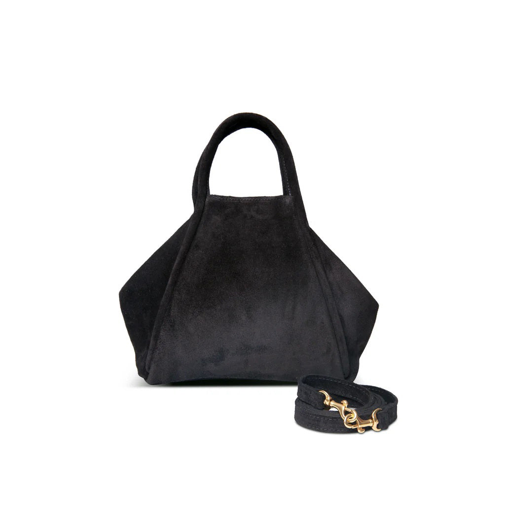 The OLIVEVE Taya Top Handle Crossbody in black Italian leather-backed suede is showcased on a white background. With angular sides, short handles, and a detachable crossbody strap featuring gold clasps, this elegant design blends style and versatility.