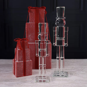ZODAX GLASS DECOR NUTCRACKER 16″ clear glass figurine standing on a square base, resembling the elegant silhouette of a 16-inch glass vase.