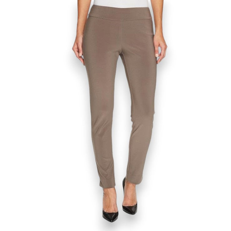A person is wearing the MICROFIBER PULL ON PANT - LONG by KRAZY LARRY, INC in taupe microfiber and black pointed heels, standing against a plain white background. The pants have a fitted appearance, and the person&#39;s arms are cropped out of the image. Made in USA.