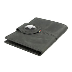 The GARZINI RFID-blocking leather passport holder in black features an AirTag compartment and snap button closure, shown on a white background.