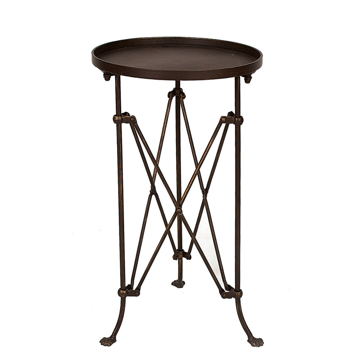 The CREATIVE COOP BRONZE FINISH METAL ACCENT TABLE holds a glass jar candle and a small flowering plant on a wooden floor, with framed artwork and photos displayed on the light-colored wall behind it.